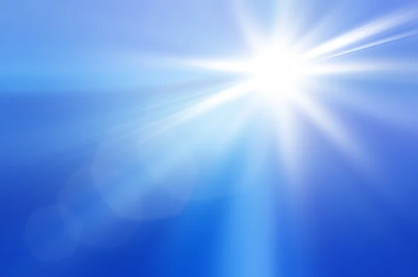 Солнце на голубом небе с лучами и вспышками — стоковое фото
